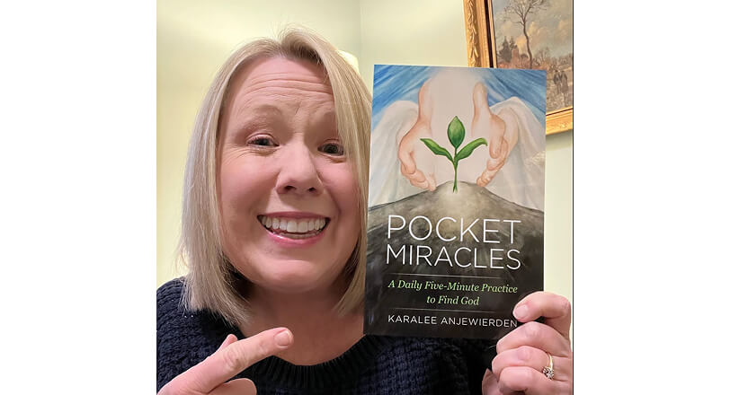 Smiling woman holding a book Smiling woman holding a book