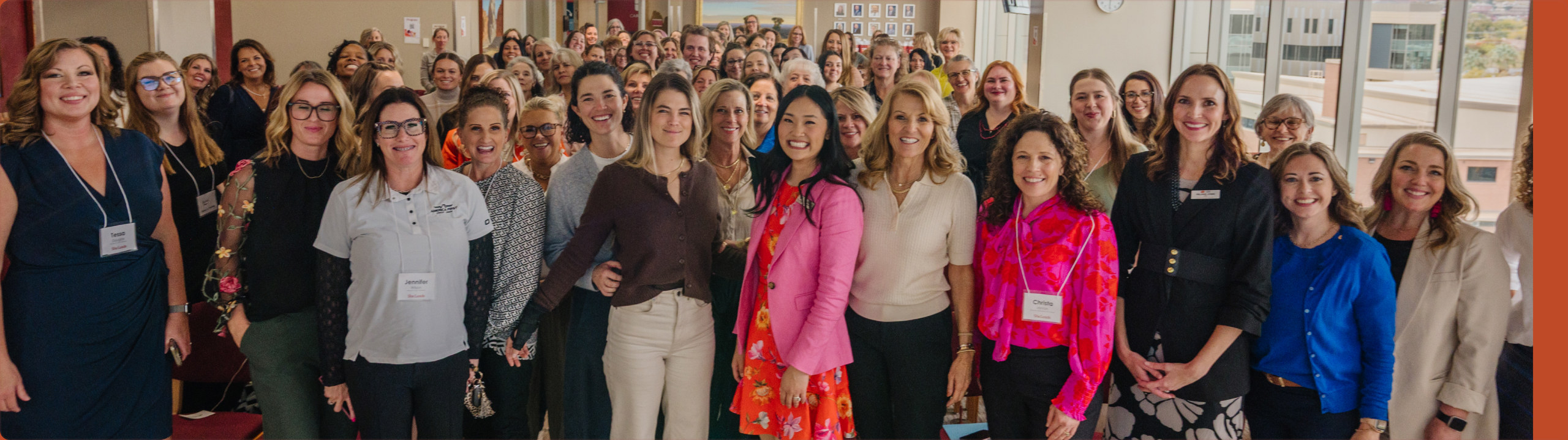 A large group of SheLeads conference attendees standing together for a photo A large group of SheLeads conference attendees standing together for a photo